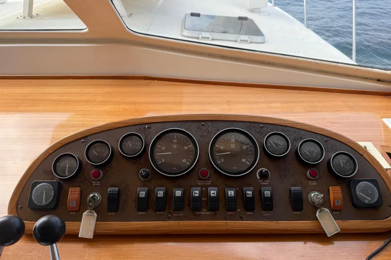 Slide: The Image of 1998 Riviera Convertible boat dashboard with gauges and controls, overlooking the ocean. - 40