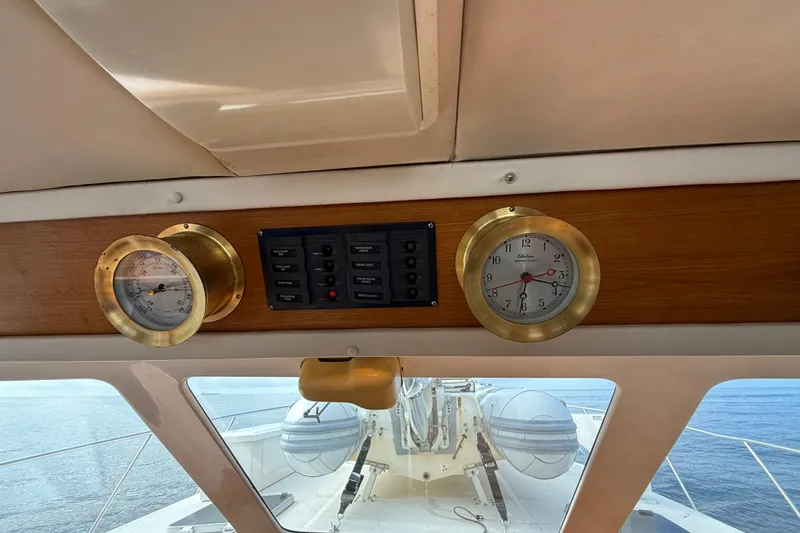 Slide: The Image of Interior of 1998 Riviera Convertible yacht with brass instruments and ocean view. - 42