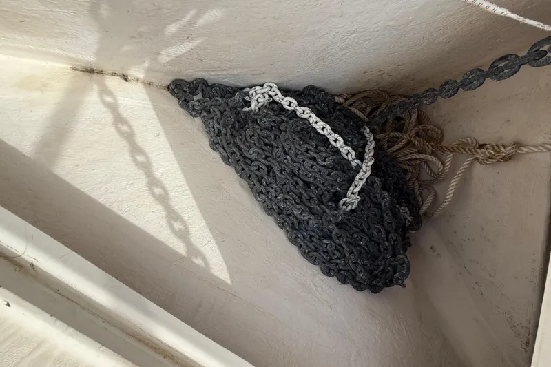 Slide: The Image of Tangled chains and ropes in a 1998 Riviera Convertible boat compartment. - 45