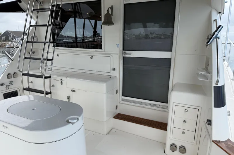 Slide: The Image of 1998 Riviera Convertible yacht deck with ladder and storage compartments. - 6