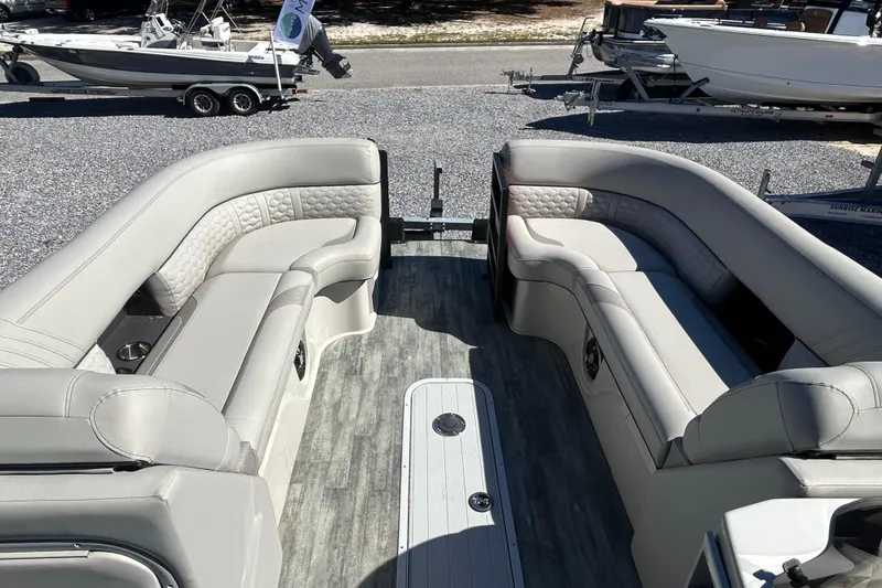 Slide: The Image of 2023 Crest Caribbean Platinum 230 interior with gray seating and wood-style flooring. - 8