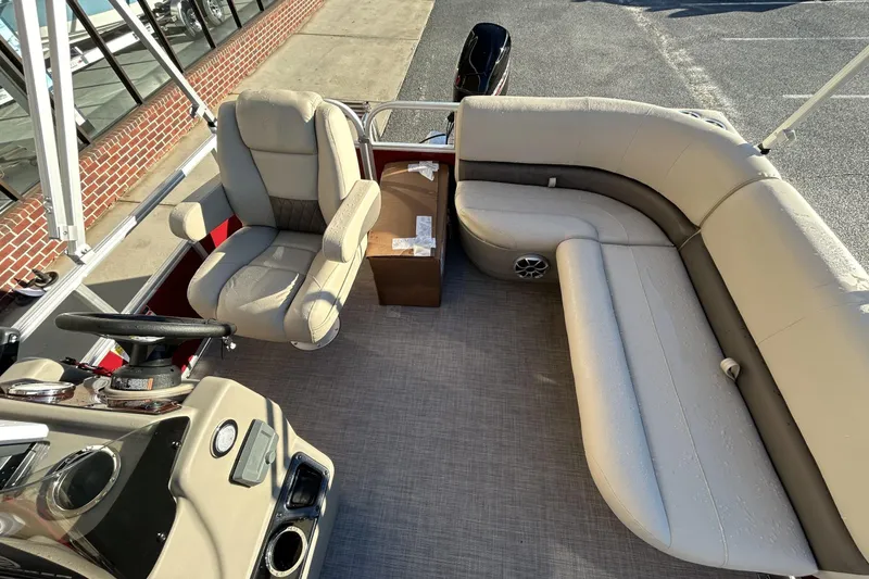 Slide: The Image of 2024 Sun Tracker Bass Buggy 16 XL Select interior with beige seating and steering console. - 5