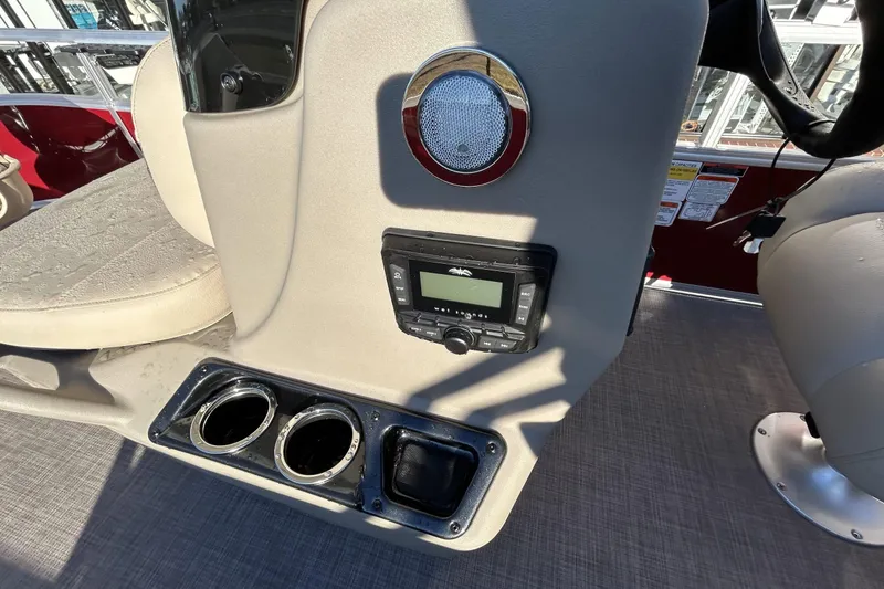 Slide: The Image of 2024 Sun Tracker Bass Buggy 16 XL Select console with stereo and cup holders. - 6