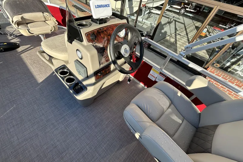 Slide: The Image of 2024 Sun Tracker Bass Buggy 16 XL Select interior with steering wheel and seating. - 7
