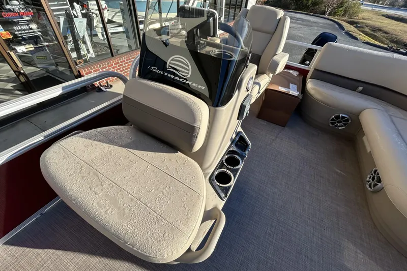 Slide: The Image of 2024 Sun Tracker Bass Buggy 16 XL Select interior with beige seating and console. - 9