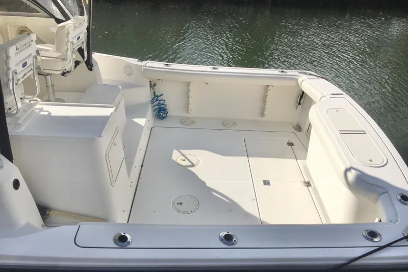 Slide: The Image of 2002 Shamrock 290 Walkaround boat deck with seating and storage compartments. - 10