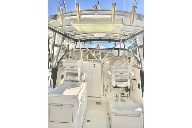 Slide: The Image of 2002 Shamrock 290 Walkaround boat interior with seating and helm station. - 7