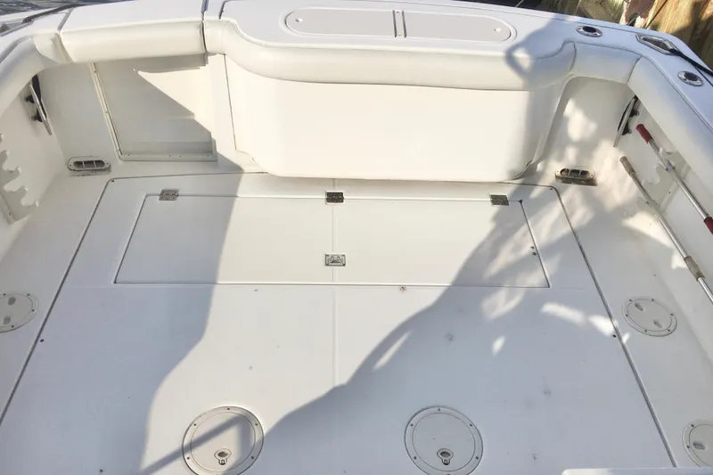 Slide: The Image of 2002 Shamrock 290 Walkaround boat deck with storage compartments and seating. - 9