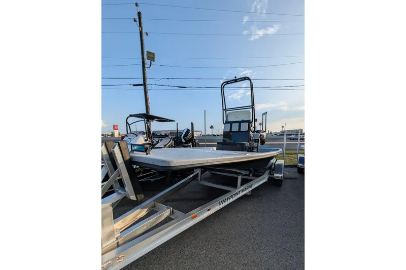 The Image of 2026 Freedom Boats 21' Commander on trailer, parked outdoors under clear sky. - 1