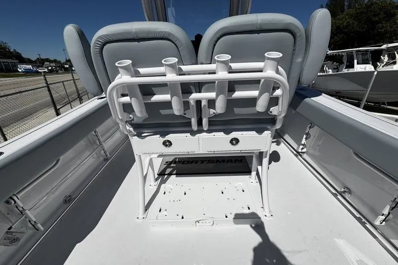 Slide: The Image of 2026 Sportsman Open 232 Center Console boat interior with rod holders and seating. - 19
