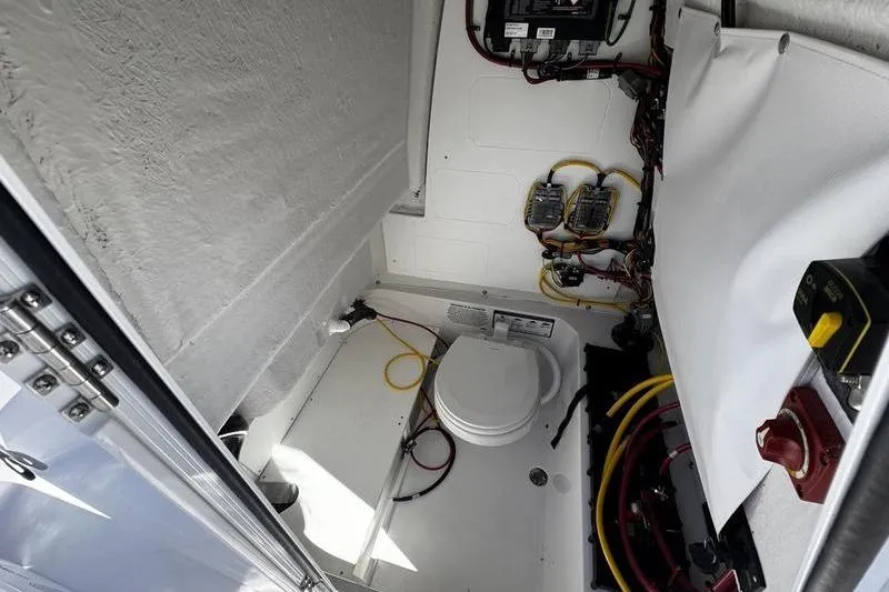 Slide: The Image of 2026 Sportsman Open 232 Center Console interior with wiring and marine toilet. - 22