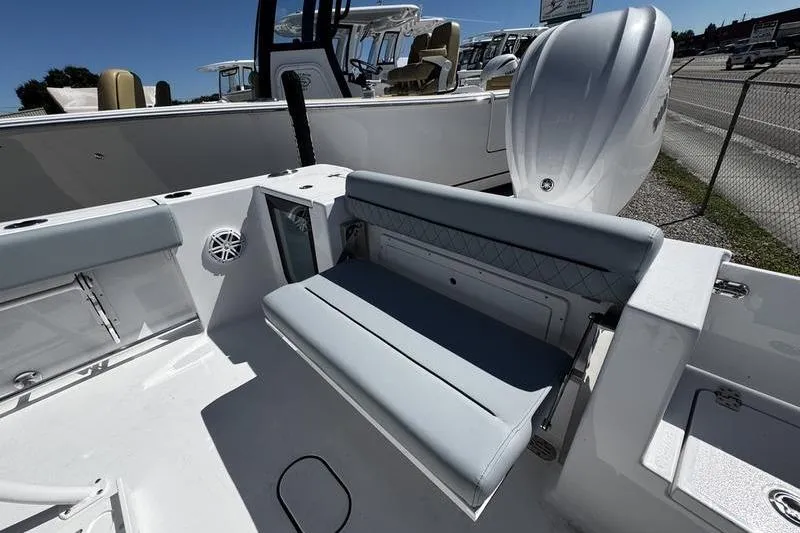 Slide: The Image of 2026 Sportsman Open 232 Center Console boat with cushioned seating and modern design. - 24