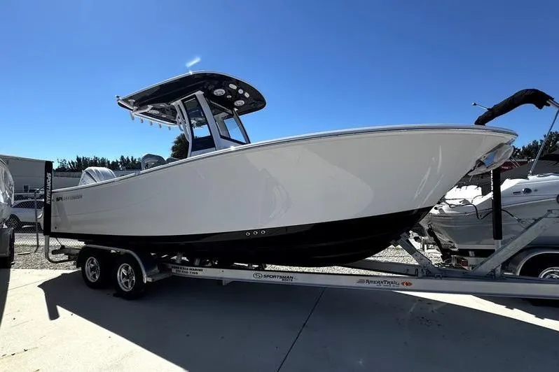 Slide: The Image of 2026 Sportsman Open 232 Center Console boat on trailer under clear blue sky. - 4