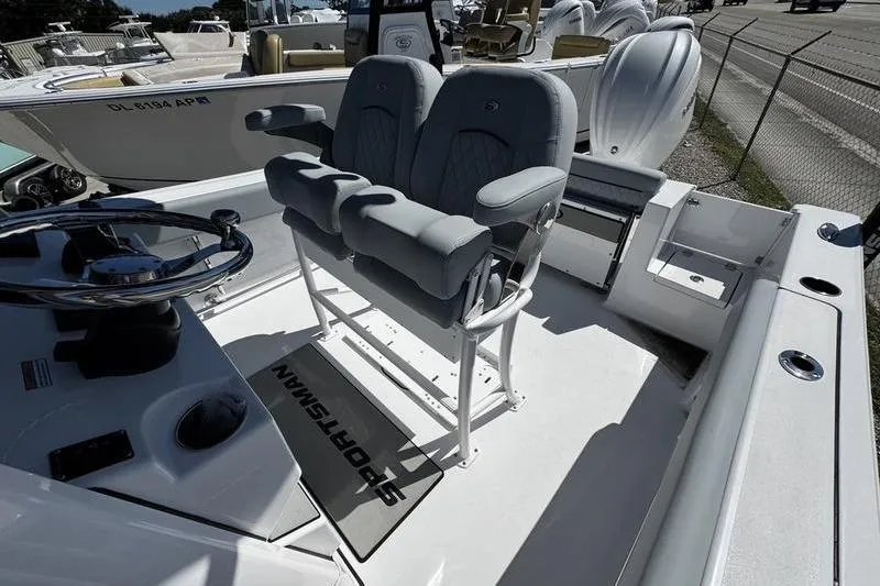 Slide: The Image of 2026 Sportsman Open 232 Center Console boat interior with dual seats and steering wheel. - 6