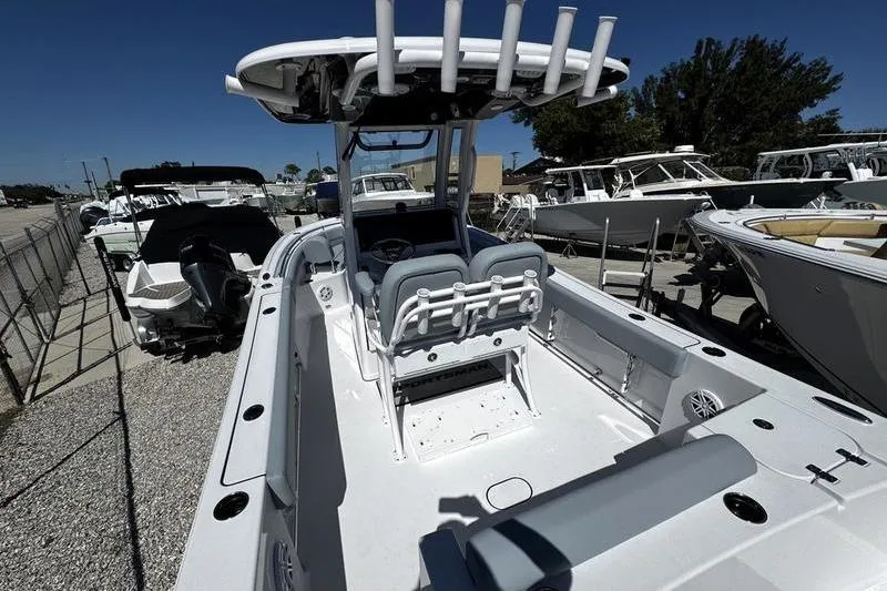 Slide: The Image of 2026 Sportsman Open 232 Center Console boat in a marina, showcasing seating and helm. - 8
