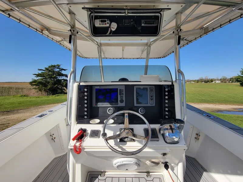 Slide: The Image of 1996 Venture 34 Center Console boat helm with navigation equipment and steering wheel. - 10