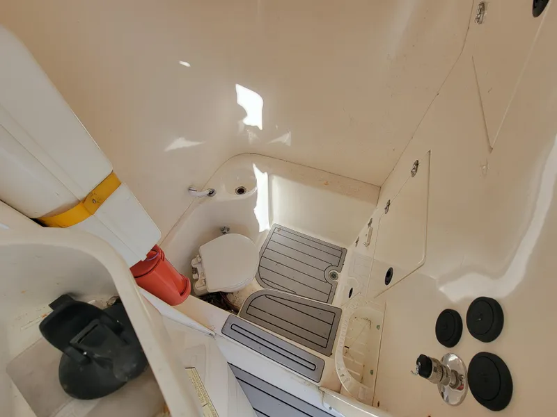 Slide: The Image of 1996 Venture 34 Center Console boat interior with toilet and storage compartments. - 11