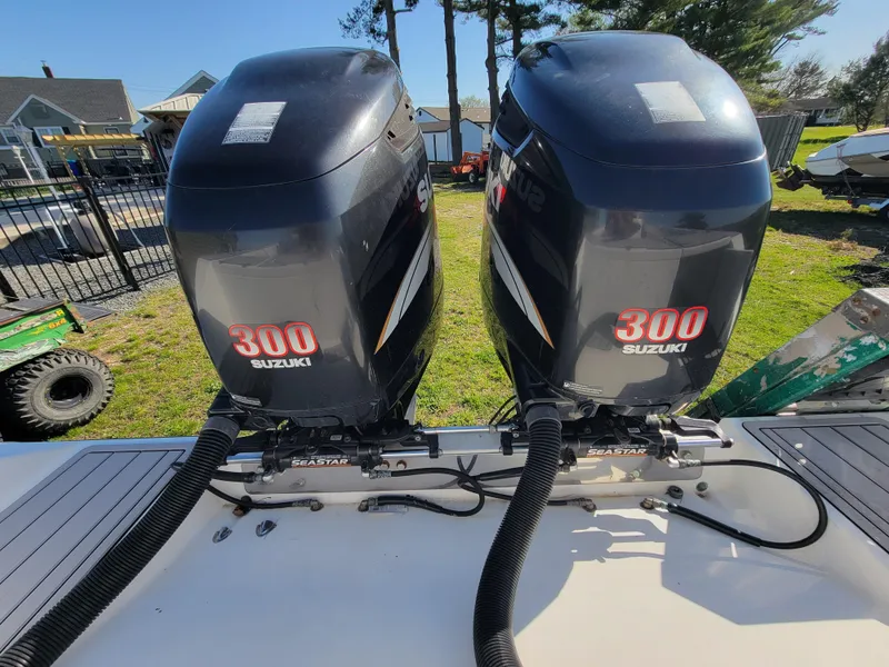 Slide: The Image of Twin Suzuki 300 outboard engines on a 1996 Venture 34 Center Console boat. - 13