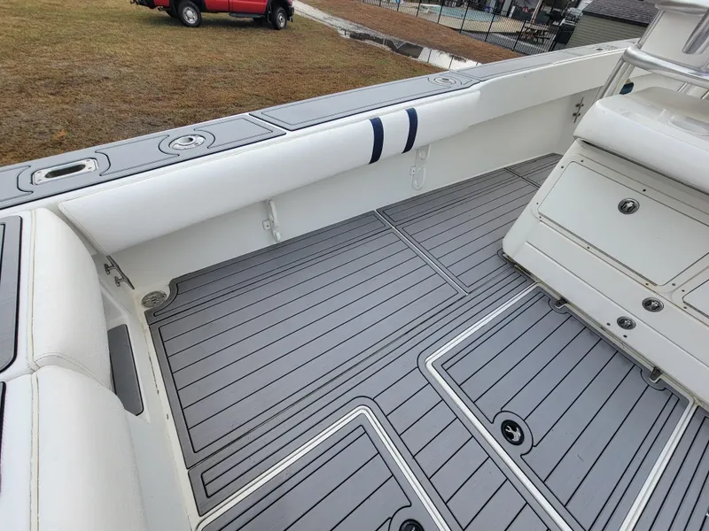 Slide: The Image of 1996 Venture 34 Center Console boat interior with gray deck and white seating. - 17