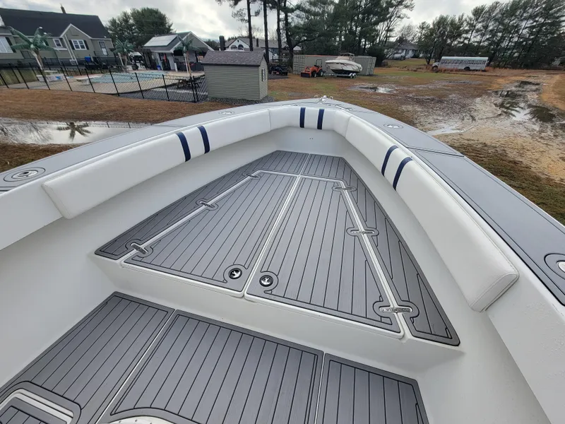 Slide: The Image of 1996 Venture 34 Center Console boat with spacious deck and cushioned seating. - 19