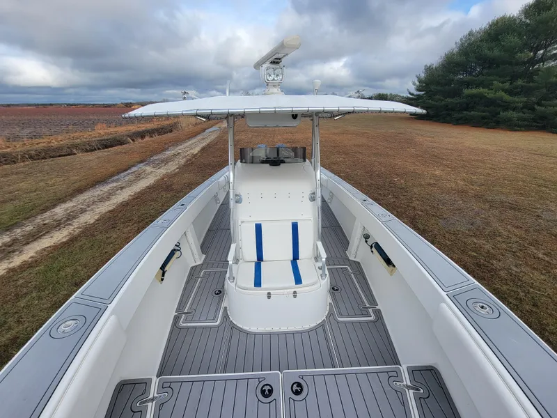 Slide: The Image of 1996 Venture 34 Center Console boat on land, cloudy sky background. - 21