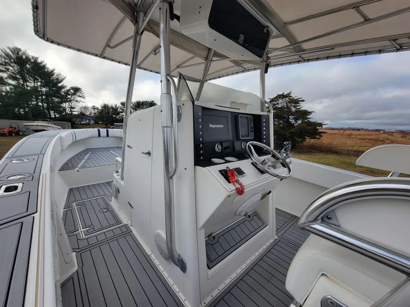 Slide: The Image of 1996 Venture 34 Center Console boat with modern helm and spacious deck. - 26