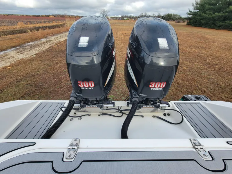 Slide: The Image of Twin Suzuki 300 outboard engines on a 1996 Venture 34 Center Console boat. - 27