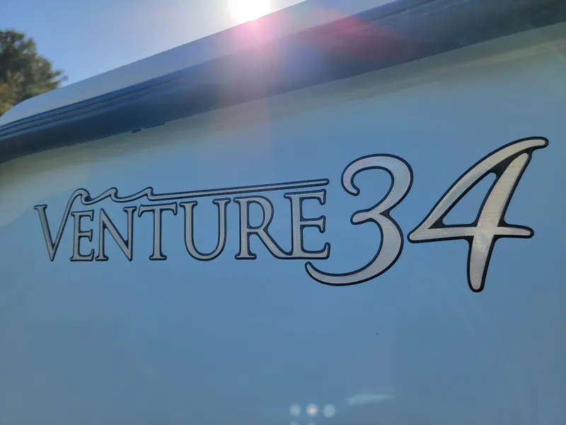 Slide: The Image of 1996 Venture 34 Center Console boat logo in sunlight. - 6
