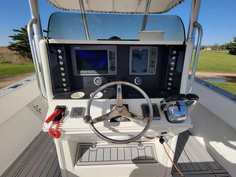 Slide: The Image of 1996 Venture 34 Center Console boat dashboard with steering wheel and navigation equipment. - 9