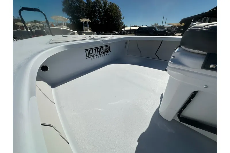 Slide: The Image of 2026 Delta Boatworks Delta D18 interior, showcasing spacious deck and seating under clear blue sky. - 11