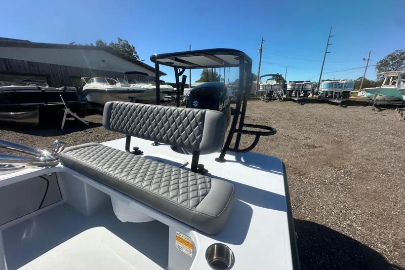 Slide: The Image of 2026 Delta Boatworks Delta D18 with quilted seating, displayed outdoors among other boats. - 15