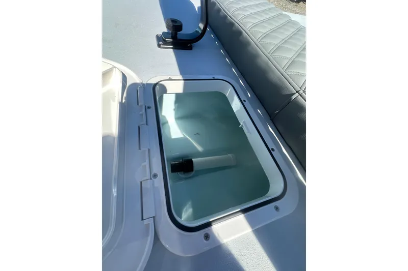 Slide: The Image of 2026 Delta Boatworks Delta D18 livewell with open lid and cushioned seating. - 23
