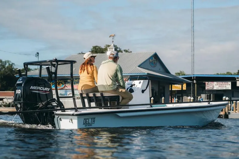 Slide: The Image of Manufacturer Provided Image: 2025 Delta Boatworks Delta D18 cruising near a marina, powered by a Mercury 50 engine. - 33