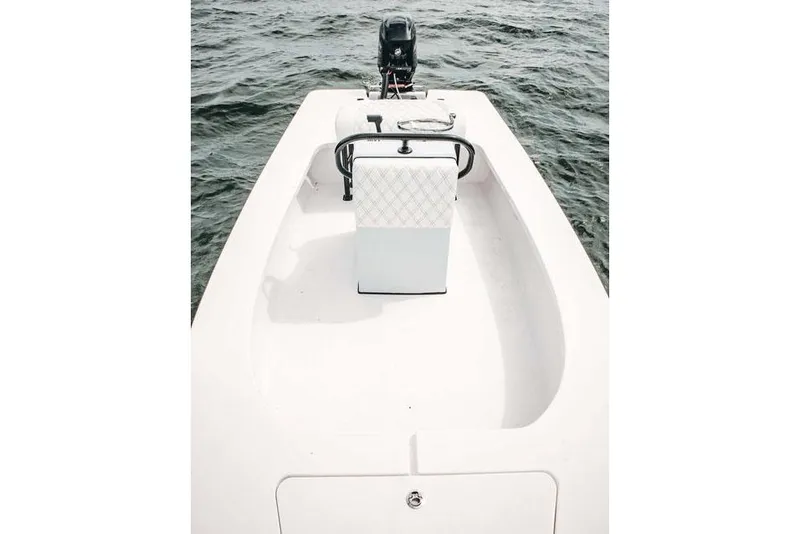 Slide: The Image of 2026 Delta Boatworks Delta D18, sleek design, parked outdoors under clear blue sky. - 8