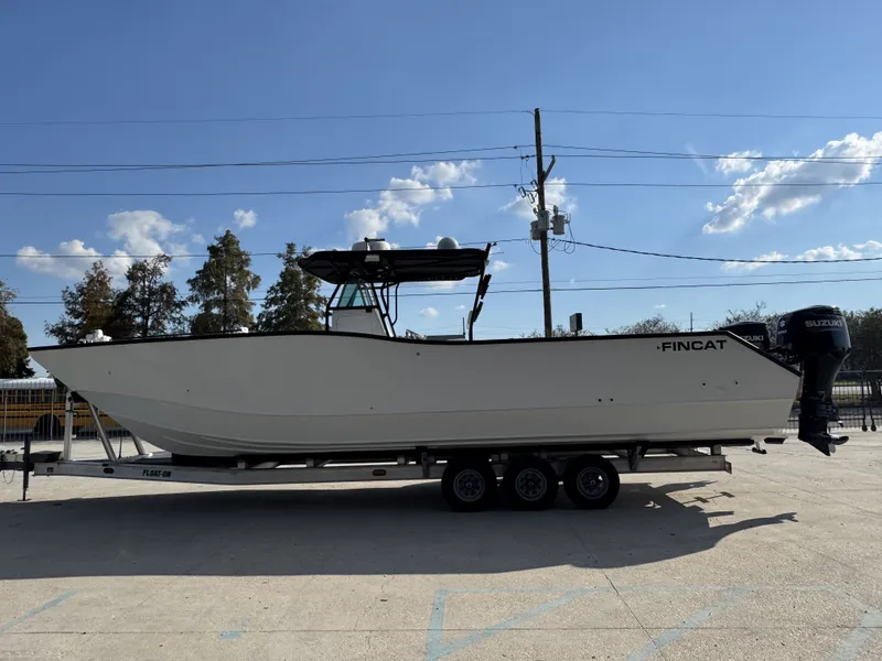 Slide: The Image of 2005 FinCat 35 boat on trailer under clear blue sky. - 15