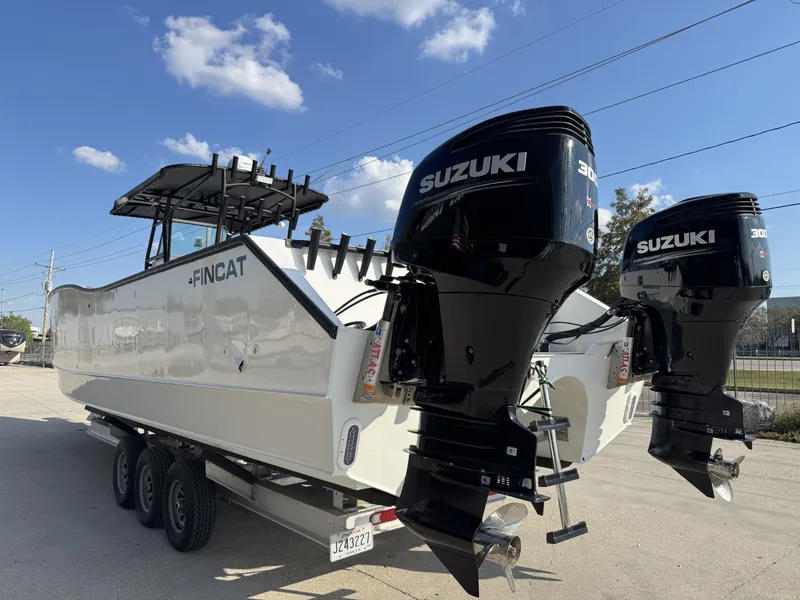 Slide: The Image of 2005 FinCat 35 boat with dual Suzuki 300 engines on a trailer. - 18