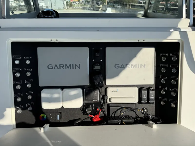 Slide: The Image of Control panel of a 2005 FinCat 35 boat featuring Garmin navigation systems. - 22