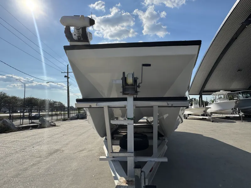 Slide: The Image of 2005 FinCat 35 boat on trailer under sunny sky, parked outdoors. - 3