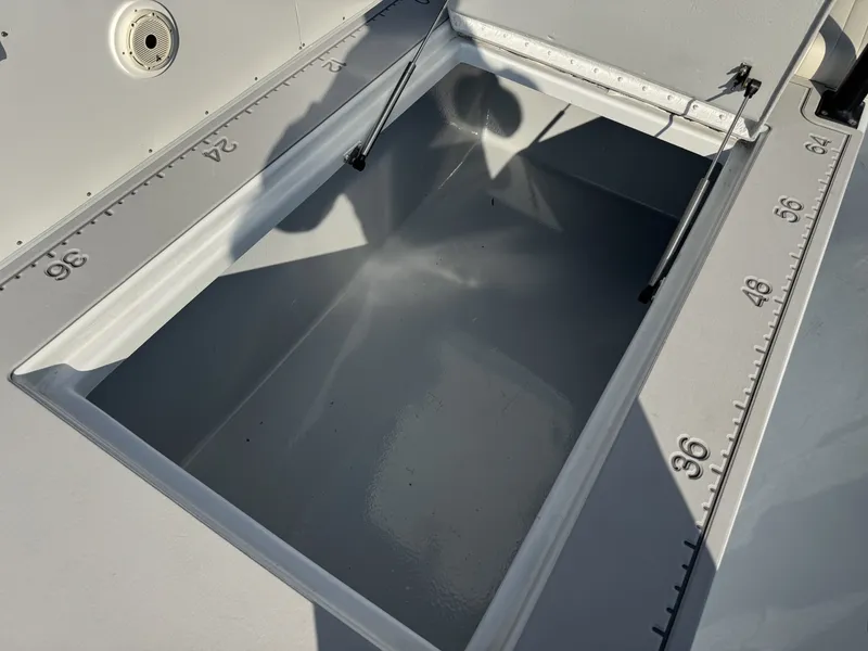 Slide: The Image of Open storage compartment on a 2005 FinCat 35 boat with measurement markings. - 9