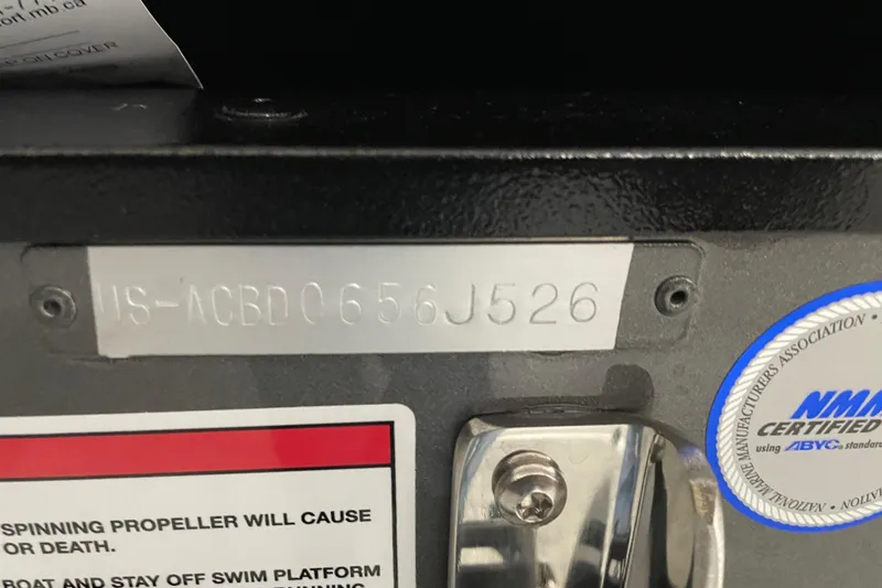 Slide: The Image of 2026 Alumacraft Competitor 185X Sport boat identification plate and safety warning labels. - 18