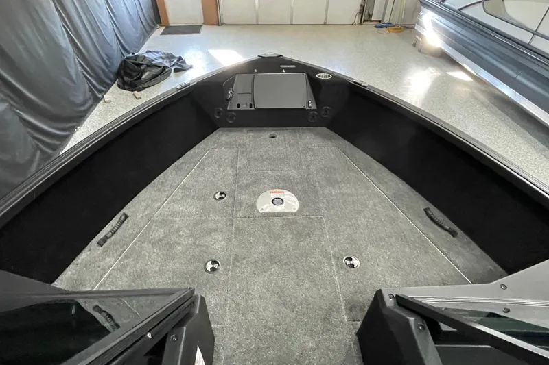 Slide: The Image of 2026 Alumacraft Competitor 185X Sport boat interior with spacious deck and storage compartments. - 6