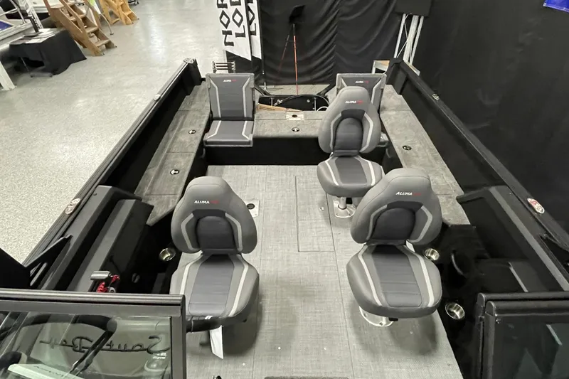 Slide: The Image of 2026 Alumacraft Competitor 185X Sport boat interior with four gray seats and spacious layout. - 7