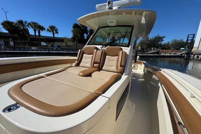 Slide: The Image of 2019 Scout 355 LXF boat with luxurious tan seating and sleek design. - 13
