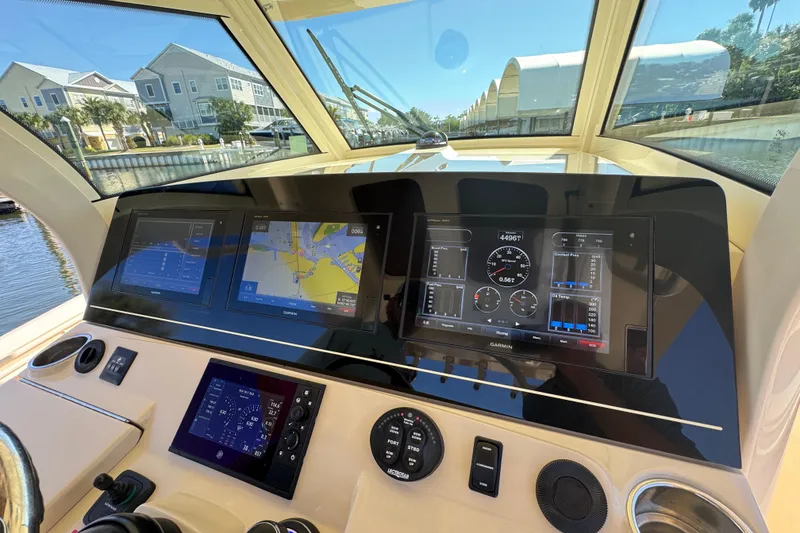 Slide: The Image of 2019 Scout 355 LXF boat dashboard with advanced navigation and control displays. - 17