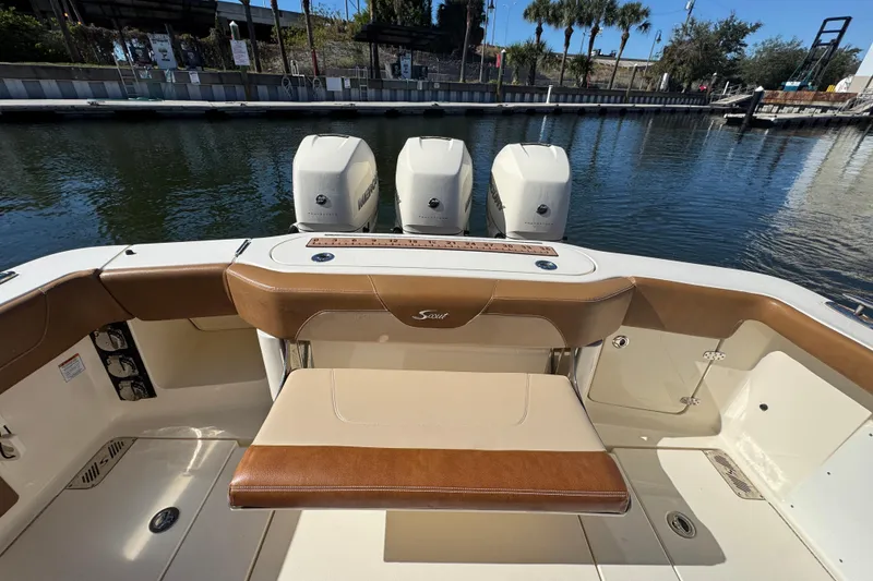 Slide: The Image of 2019 Scout 355 LXF boat interior with triple outboard engines at dock. - 21