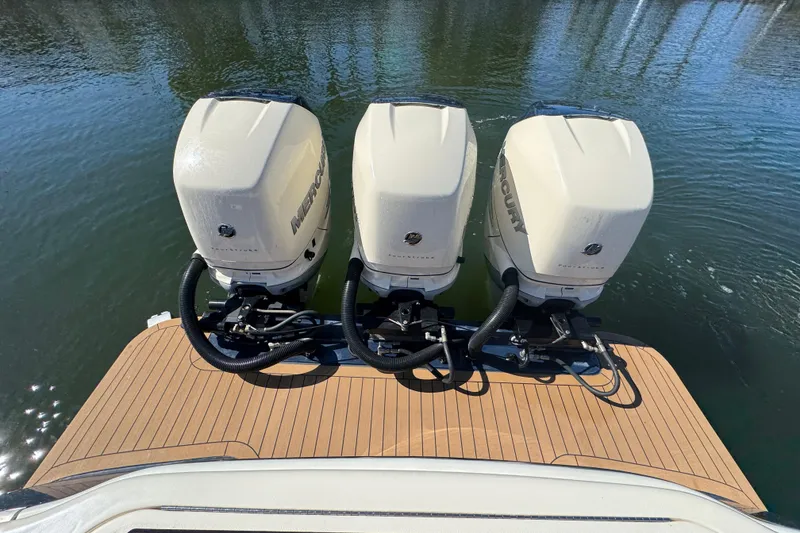 Slide: The Image of 2019 Scout 355 LXF boat with triple Mercury outboard engines on water. - 24