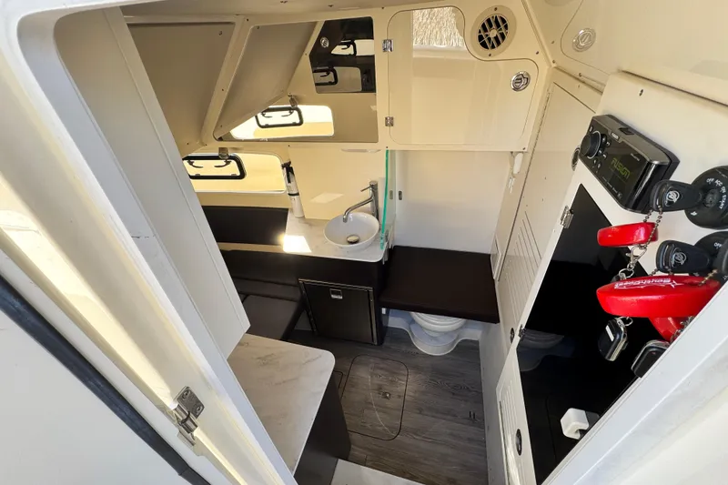 Slide: The Image of 2019 Scout 355 LXF boat interior with modern amenities and compact design. - 25