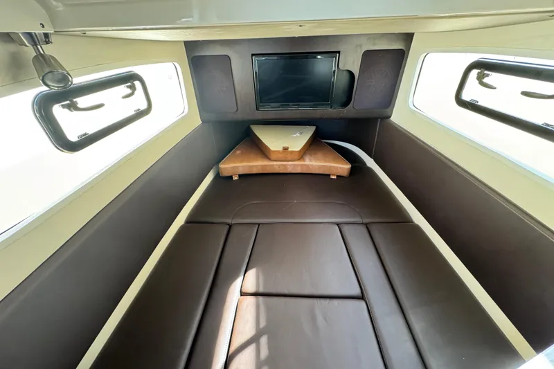 Slide: The Image of 2019 Scout 355 LXF cabin interior with brown seating and windows. - 29
