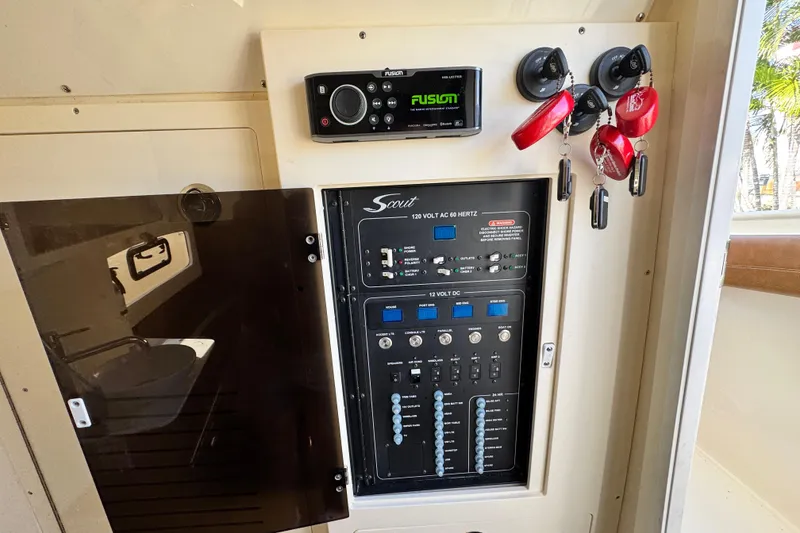 Slide: The Image of Control panel of a 2019 Scout 355 LXF boat with keys and audio system. - 32