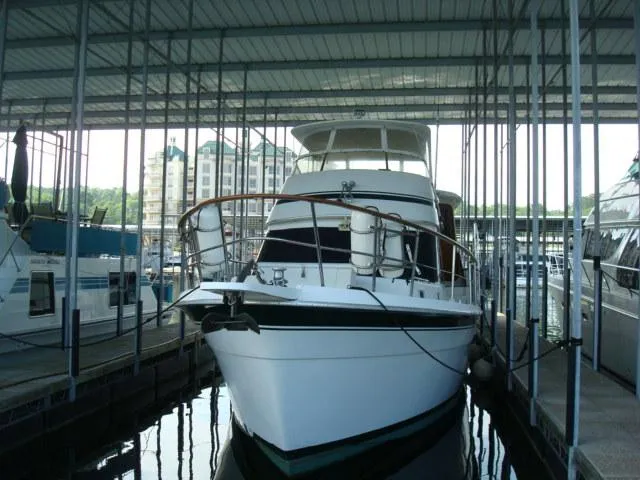 Slide: The Image of 1984 Gulfstar 49 Motor Yacht docked in a covered marina. - 1